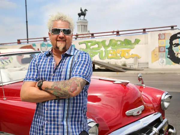 image of Guy Fieri with his car